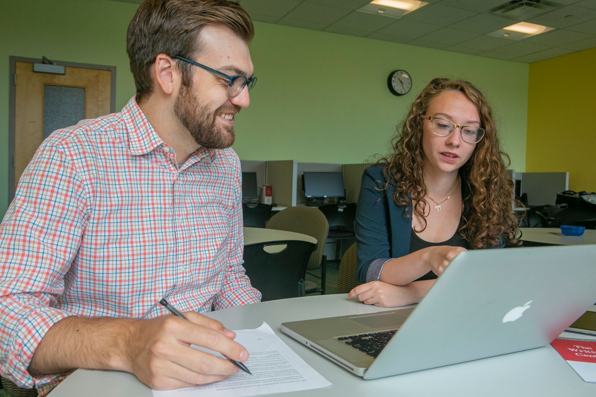 Two people working together on assignments.